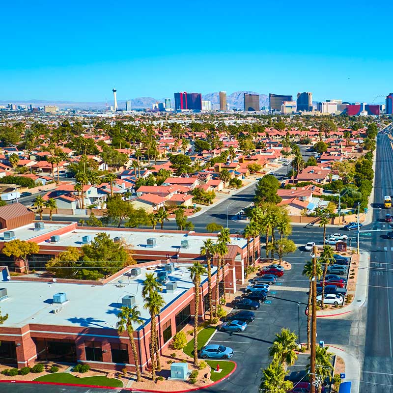 Aerial view of Las Vegas neighborhood with palm‑lined streets and skyline – factors affecting Nevada closing speed