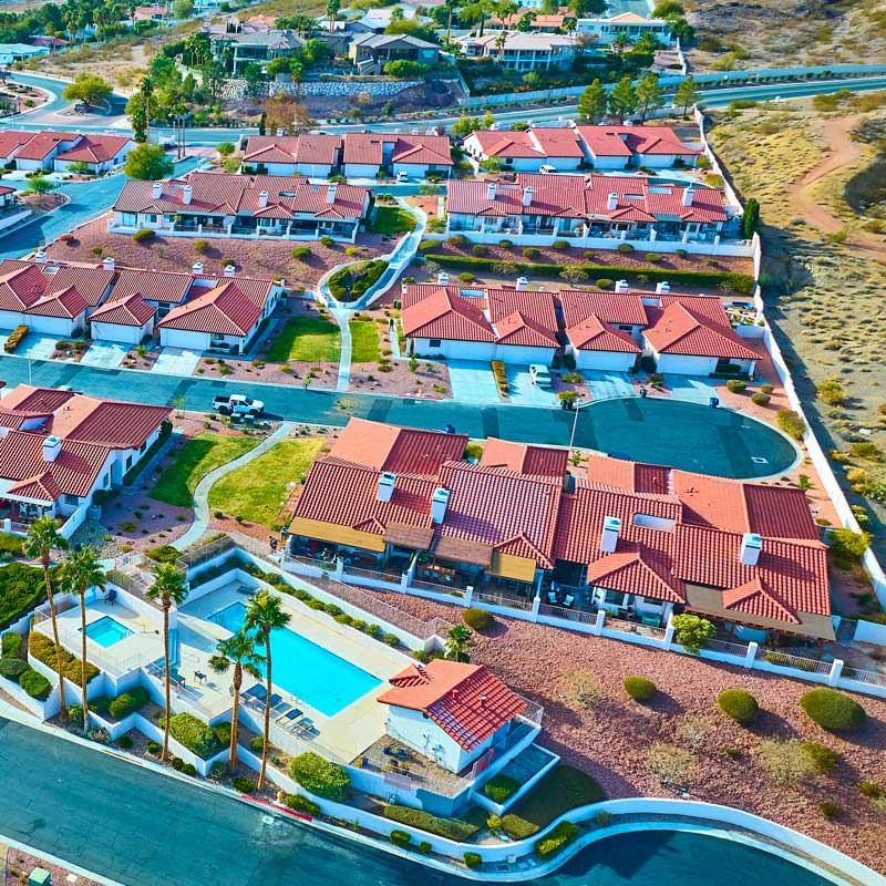 Aerial view of a master‑planned Nevada community with pool and palm trees – ideal hard money investment neighborhood