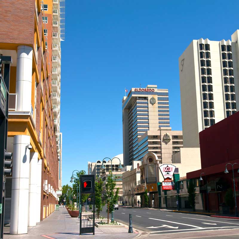 Downtown Reno street with high‑rise office and hotel buildings – Nevada commercial real estate financing